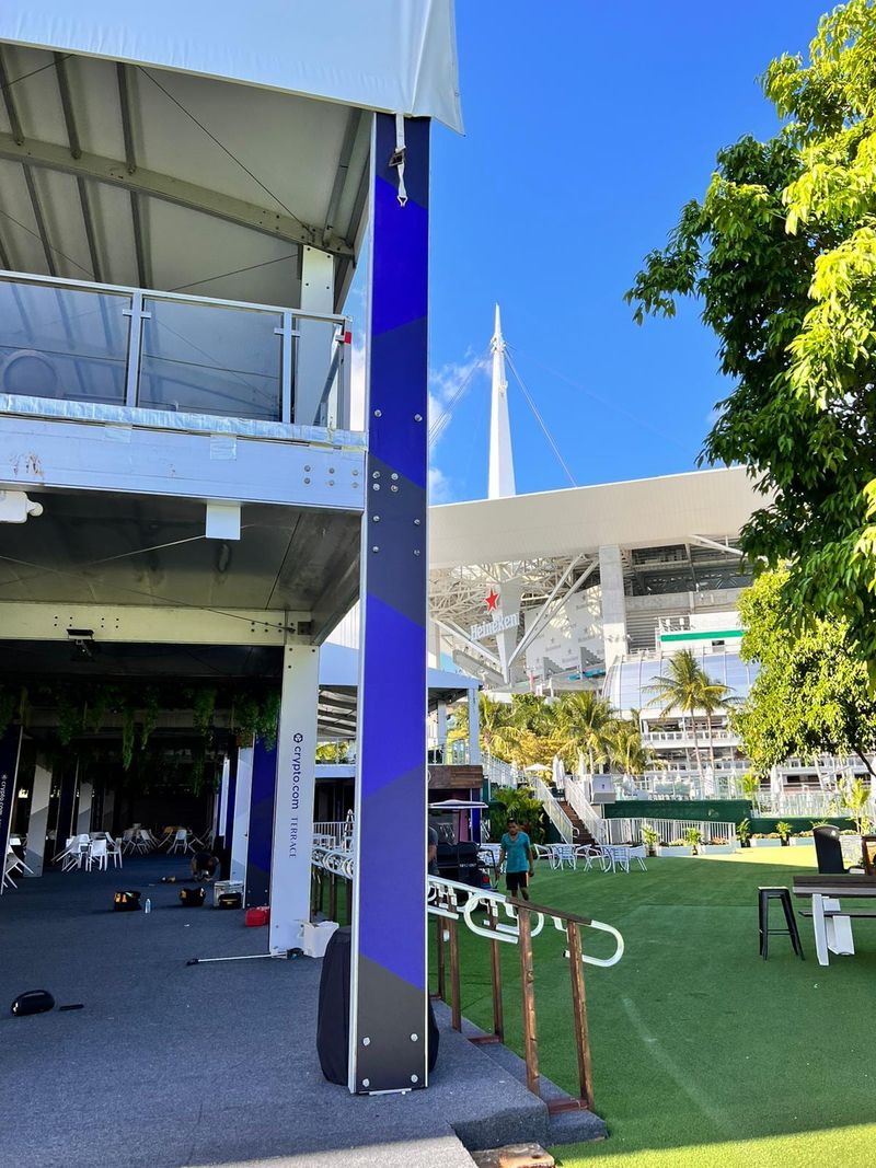Trackside hospitality structure with printed panel cladding, Hard Rock Stadium visible behind