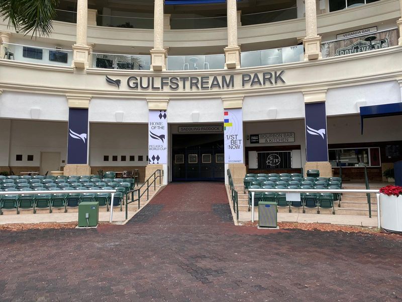 Pegasus World Cup banners and betting signage installed at the Gulfstream Park saddling paddock entrance